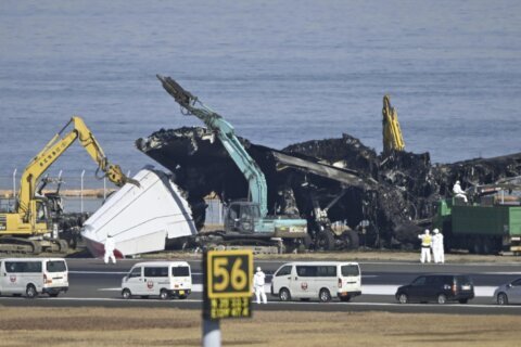 Japanese safety experts search for voice data as workers clear plane debris from runway collision