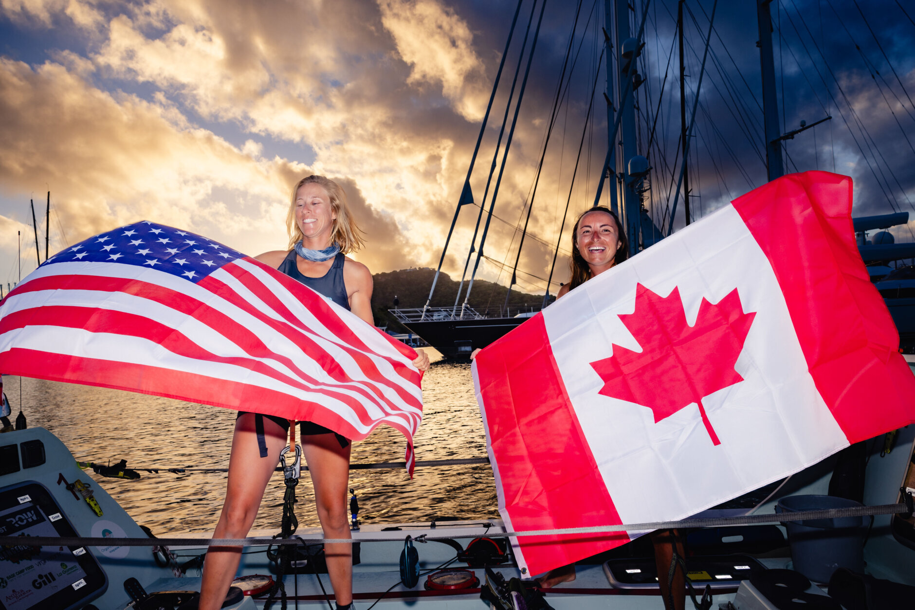 Lauren Champion and Lisa Roland hold up flags of respective countries