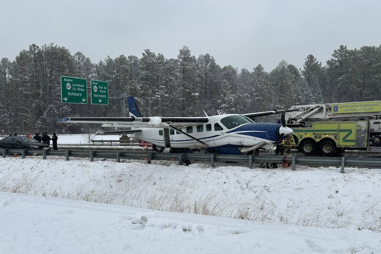 A small private airplane made an emergency landing on the Loudoun County Parkway near Dulles International Airport Friday afternoon. (WTOP/Neal Augenstein)