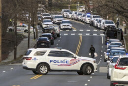 Washington Metropolitan Police are shown near a scene where three police officers were shot and a fourth suffered minor injuries while responding to a shooting, Wednesday morning, Feb. 14, 2024 in Washington. The officers are expected to survive the wounds and were being treated at area hospitals after the shooting in the nation's capital, the Metropolitan Police Department said in a statement posted online. The fourth officer's injuries were not gunshot wounds, police said. The police union said three of its members had been shot by a suspect and were taken to area hospitals with gunshot wounds. (AP Photos/Nathan Ellgren)