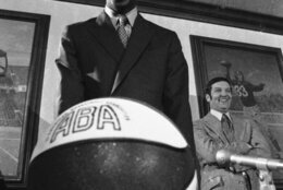 Charlie Scott fields questions at a Washington news conference after he signed with the Washington Capitals, March 16, 1970, in Washington.  Scott, 22, a New York City native, was the first African American to play for the University of North Carolina.  At right is the Caps' president, Earl M. Foreman.  (AP Photo/Bob Daugherty)