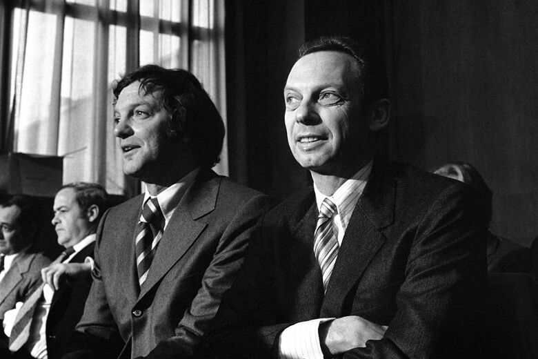 Earl Foreman, left, owner of the Virginia Squires of the American Basketball Association, and Abe Pollin, who owns the Baltimore Bullets of the National Basketball Association, meet at a Senate antitrust subcommittee hearing on a possible NBA-ABA merger in Washington on Jan. 25, 1972. (AP Photo/Bob Daugherty)