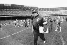 Washington Redskins head football coach Joe Gibbs, who guided the defending Super Bowl champion Redskins to the top of the National Football League standings in 1983, was named to day the Associated Press Coach of the Year, Saturday, Dec. 20, 1983, Washington, D.C. Gibbs is shown leaving the field at RFK Stadium after defeating the New York Giants 31-22. (AP Photo/Scott Applewhite)