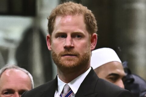 Prince Harry settles a tabloid phone hacking claim and says his mission to tame the media continues