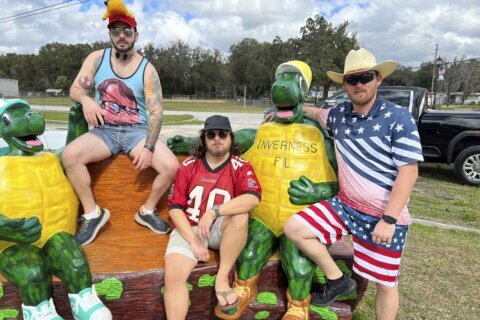 At the Florida Man Games, tank-topped teams compete at evading police, wrestling over beer