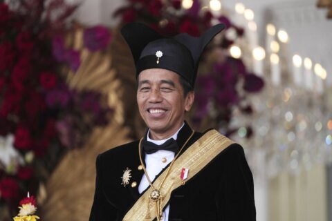Indonesia's president, who mingles with people and listens to Metallica, still popular in last term
