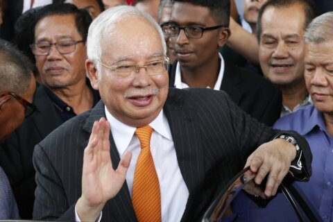 Malaysia halves prison term for ex-Prime Minister who oversaw multibillion-dollar 1MDB thefts