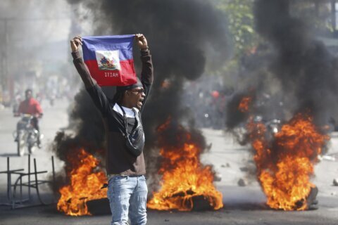 Police in Haiti struggle against gangs storming prison in latest surge of violence