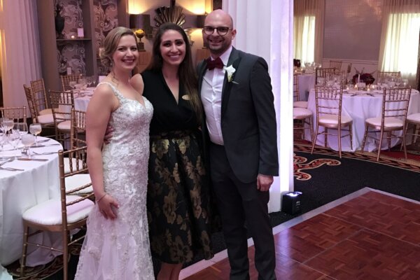 Katelyn Miner with a wedding couple
