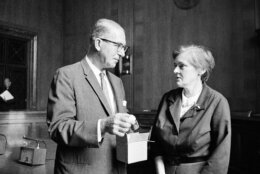 Sen. Estes Kefauver, D-Tenn., takes a bottle of thalidomide from a box as he talks with Dr. Frances Kelsey of the Food and Drug Administration, Aug. 6, 1962, in Washington. Dr. Kelsey met with the Senate judiciary Committee behind closed doors to testify in Washington on President Kennedy's proposed amendments to drug control legislation sponsored by Kefauver. (AP Photo/Henry Griffin)