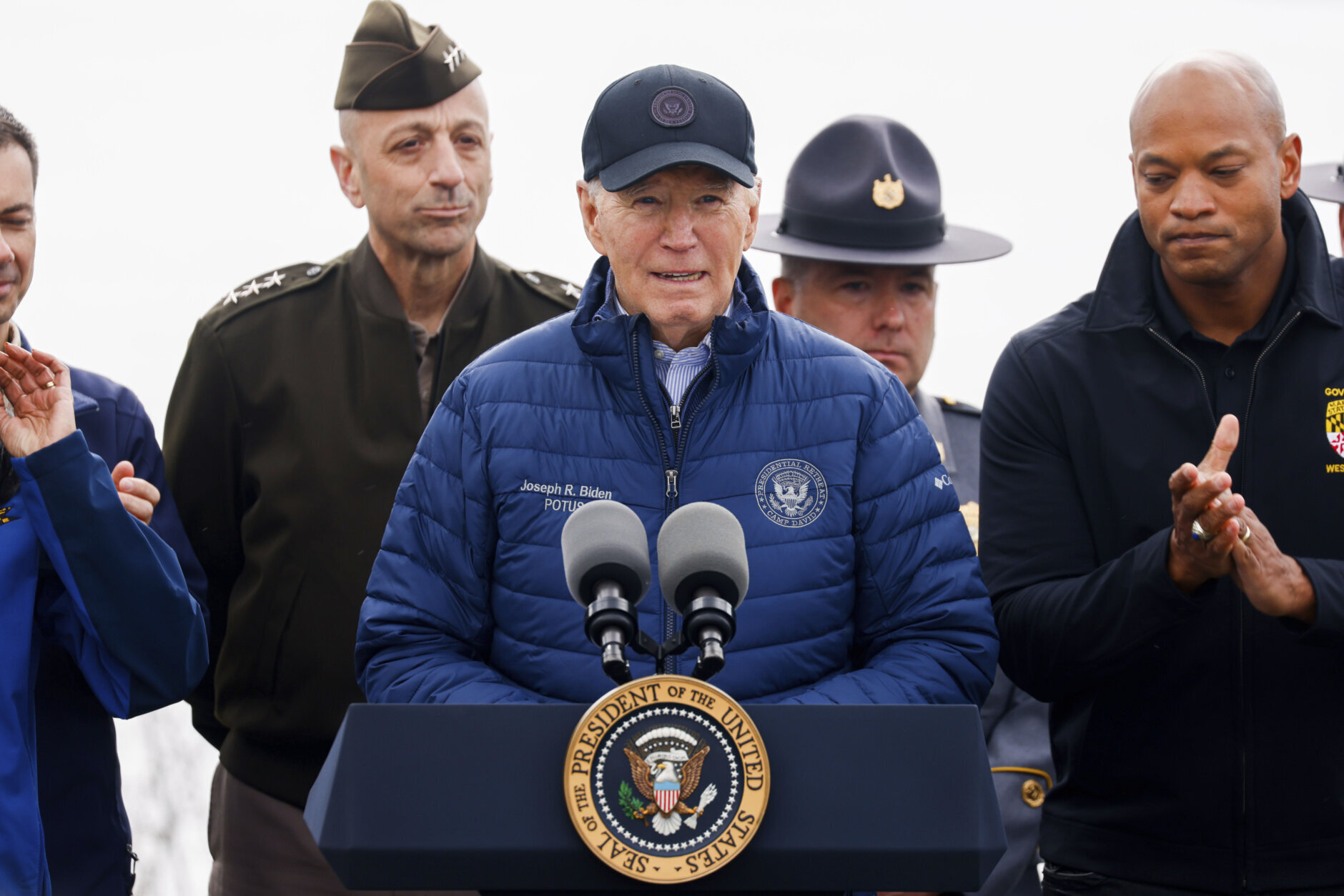 President Joe Biden speaks as Maryland Gov. Wes Moore, right, claps after an operational briefing on the response and recovery efforts of the collapsed Francis Scott Key Bridge, Friday, April 5, 2024, in Dundalk, Md. (AP Photo/Julia Nikhinson)