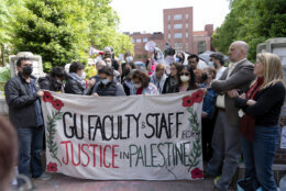 George Washington University professors Rochelle Davis, from right, and Will Youmans lead a group of professors during a pro-Palestinian protest over the Israel-Hamas war on Friday, April 26, 2024, in Washington. (AP Photo/Jose Luis Magana)