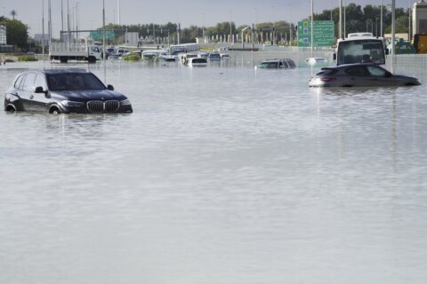 A storm dumps record rain across the desert nation of UAE and floods Dubai’s airport