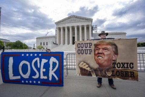 The Latest: Supreme Court justices keenly aware of implications of Trump case