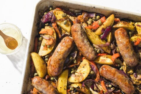 Roast Italian sausages over potatoes and peppers for a flavorful one-pan supper