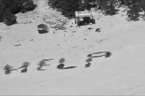 'HELP' sign on beach points rescuers to men stuck nine days on remote Pacific atoll