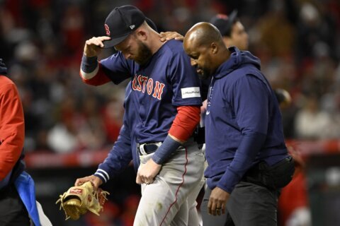 Red Sox SS Trevor Story leaves game after injuring shoulder on diving stop of Mike Trout's hit