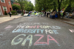 Chalk street graffiti on the campus of George Washington University that reads "Welcome to The DMV People's University for Gaza"