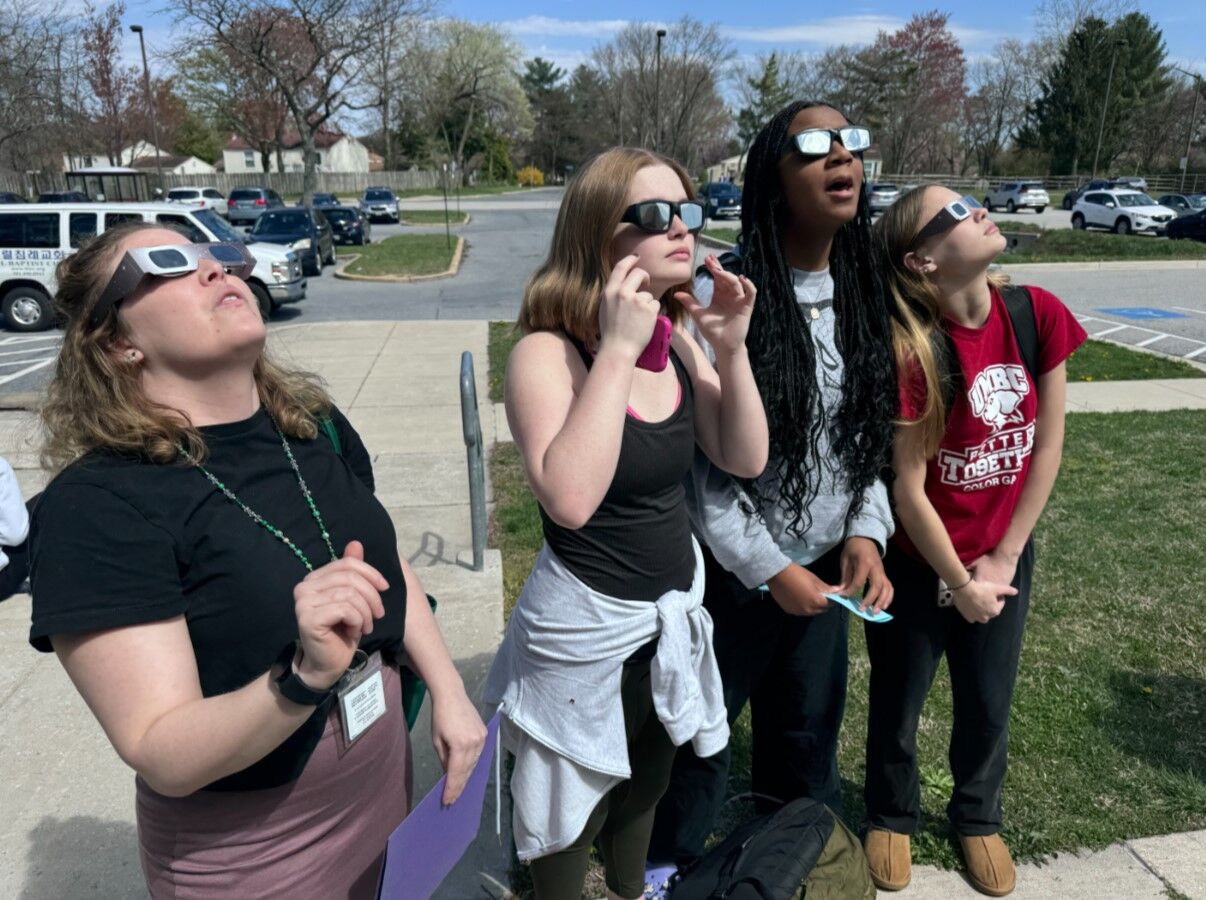Students looking up at the sun