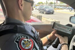 Fairfax County Police Officer Kevin Gehr uses what's known as a lidar gun to detect drivers' speeds. (WTOP/Scott Gelman)
