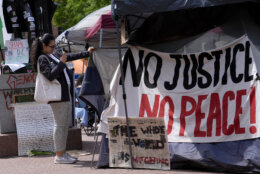 People gather near a student encampment on the campus of George Washington University in Washington, Friday, May 3, 2024, to protest the Israel-Hamas war. (AP Photo/Susan Walsh)
