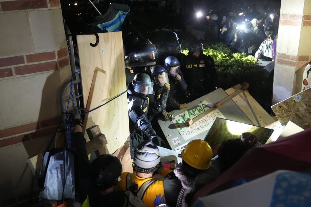 The Latest | Police break up tent camp at UCLA, take protesters into custody