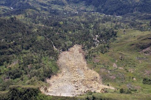 Papua New Guinea's prime minister visits the site of a landslide estimated to have killed hundreds