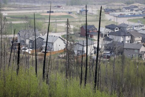 Canadians are hopeful shifting winds may push wildfire away from the oil sands hub of Fort McMurray