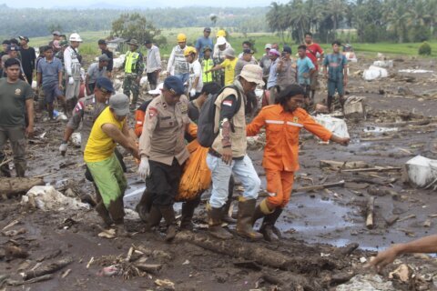 Indonesian rescuers search through rivers and rubble after flash floods that killed at least 50