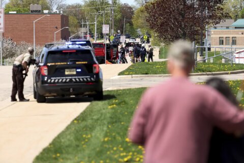 Investigators say student killed by police outside Wisconsin school had pointed pellet rifle