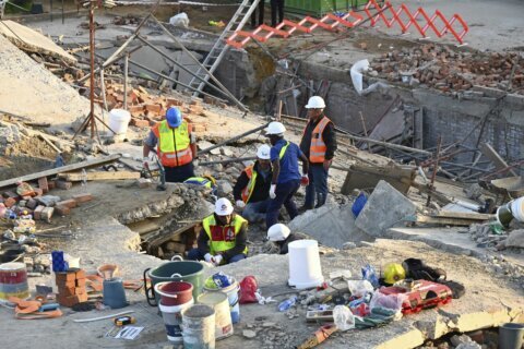 Rescuers contact some workers alive in the rubble of a deadly building collapse in South Africa