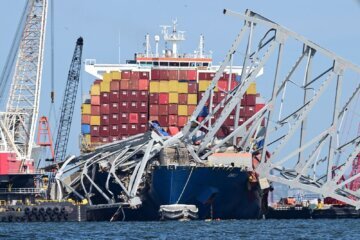 Workers continue to clear the wreckage of the Francis Scott Key Bridge and the container ship Dali in Baltimore, Maryland, on April 26. Authorities have recovered the body of a fifth victim in the Baltimore bridge collapse five weeks ago.