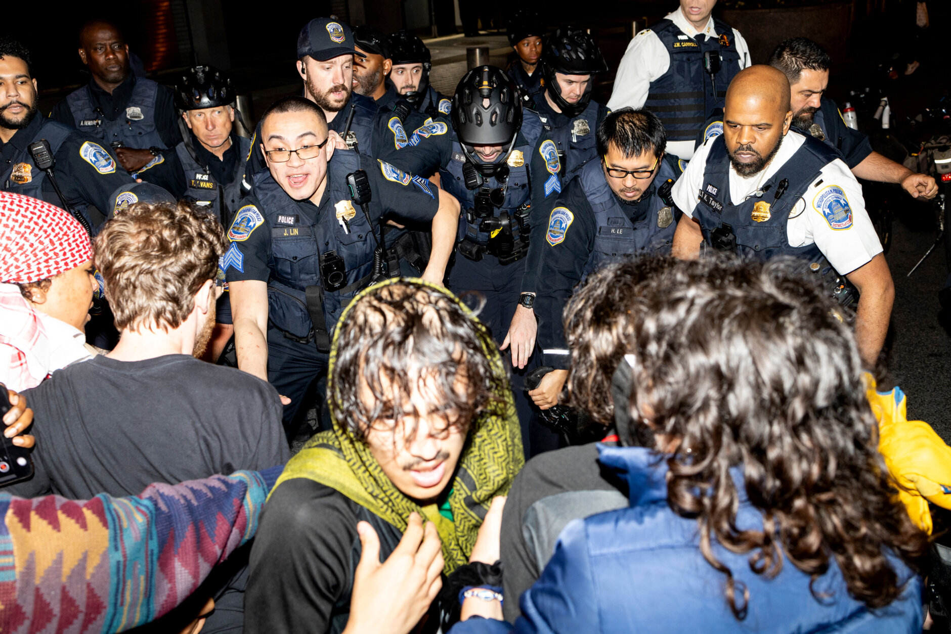Demonstrators clash with the officers from the Metropolitan Police Department at George Washington University in Washington, early Wednesday, May 8, 2024. Police cleared a pro-Palestinian tent encampment at the university and arrested demonstrators early Wednesday, hours after dozens marched to the home of the school’s president.