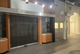 A store is gated up after closing