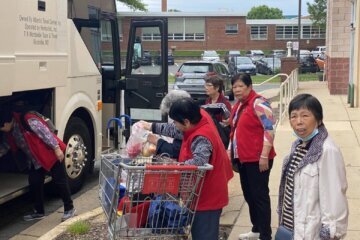 Residents of the Wah Luck House load up their groceries outside the Great Wall grocery store in Falls Church, Virginia. (WTOP/Luke Lukert)