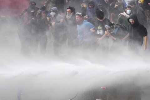 Argentine riot police disperse protesters with water cannons ahead of key Senate vote