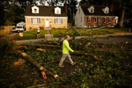 GAITHERSBURG, MARYLAND - JUNE 06: Workers survey damage the day after tornado swept through the Olde Towne neighborhood on June 06, 2024 in Gaithersburg, Maryland. The most significant twister events to strike Maryland in years, EF 2 or EF 3 tornados struck several communities in Montgomery County on Wednesday, knocking out power, up-ending trees, damaging structures and sending at least five people to the hospital. (Photo by Chip Somodevilla/Getty Images)