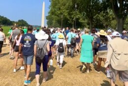 Crowds walk toward the Washington Monument, seen in the background