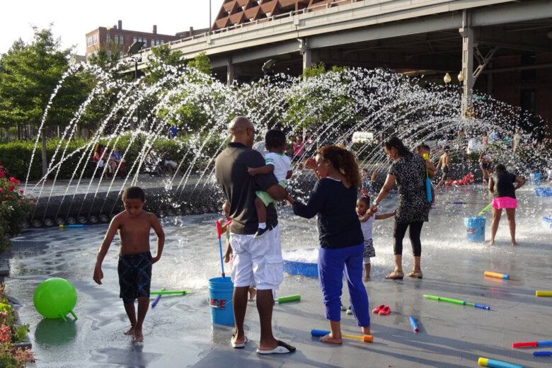Parents and children at a D.C. splash fountain