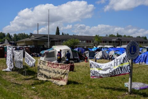 Hundreds of asylum-seekers are camped out near Seattle. There's a vacant motel next door