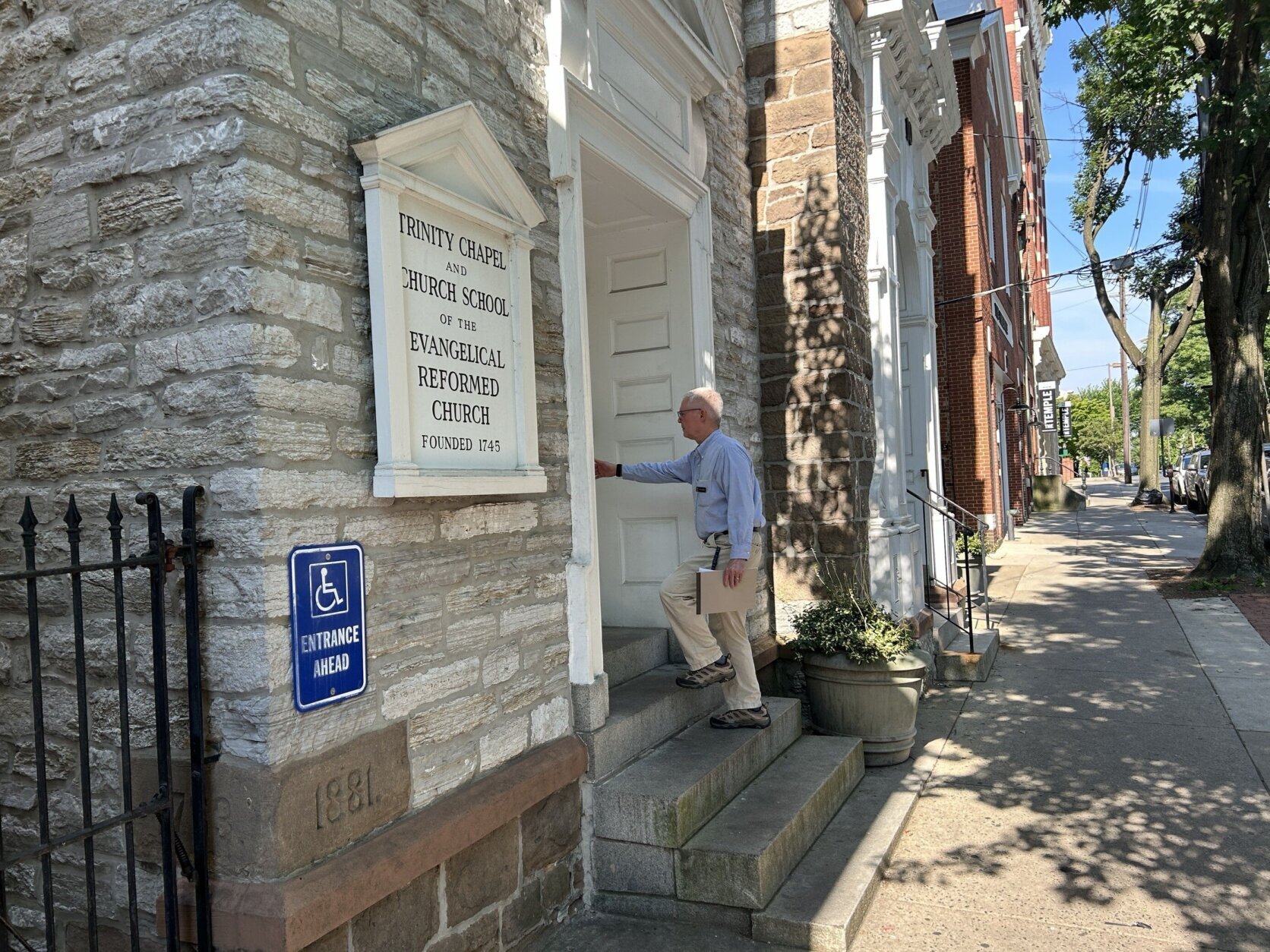 man in front of church entrance