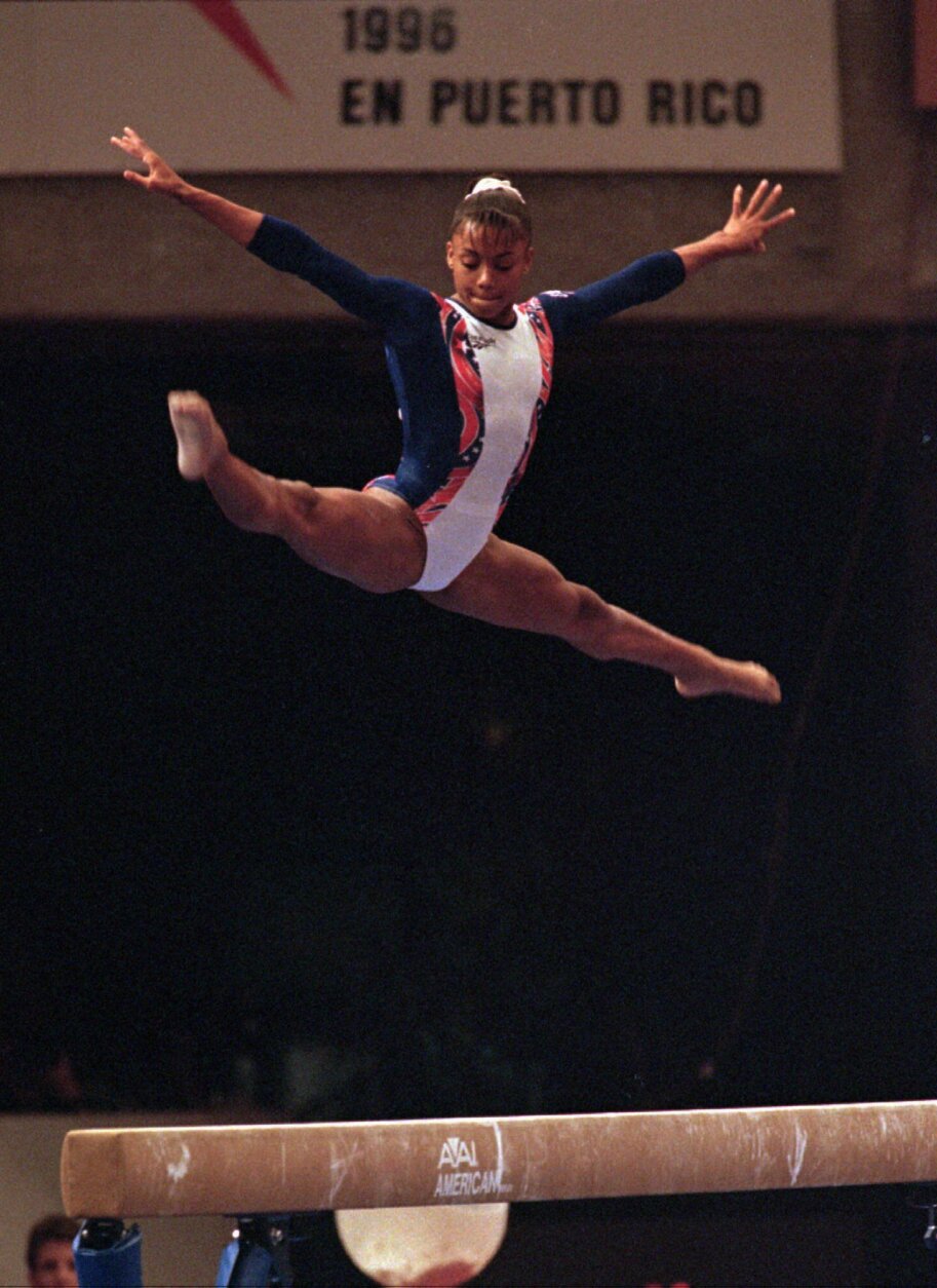 Dominique Dawes of Silver Springs, Md. competes on the balance beam during the finals of the World Gymnastics Championships in San Juan, Puerto Rico Saturday, April 20, 1996. Dawes tied for the bronze medal with Xuan Lui of China. (AP Photo/John McConnico)
