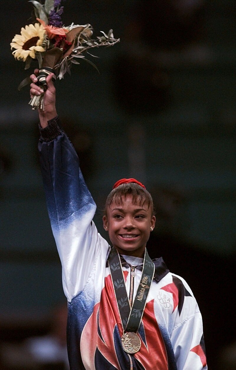 Dominique Dawes waves to the crowd after being awarded the bronze medal at the women's individual event gymnastics finals of the Centennial Summer Olympic Games in Atlanta Monday, July 29, 1996.  Dawes won the bronze in the floor exercises. (AP Photo/Susan Ragan)