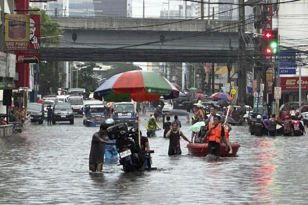 Taiwan prepares for a strong typhoon that worsened monsoon rains in the Philippines, killing 12