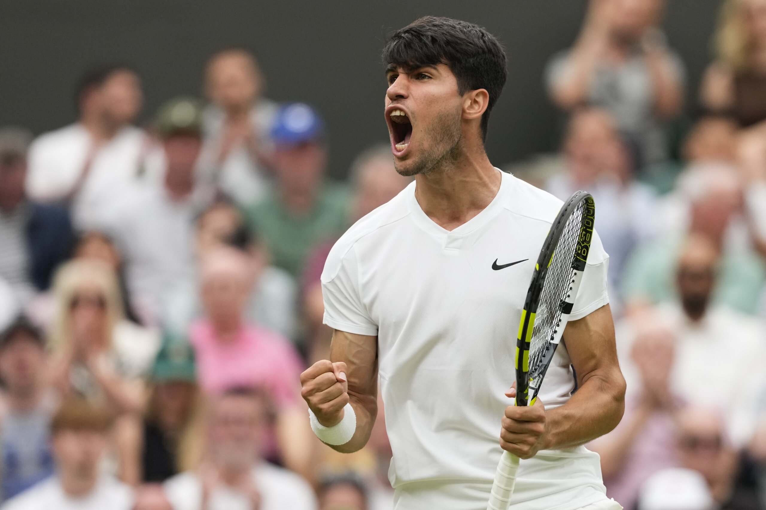 Defending Wimbledon champion Carlos Alcaraz comes back to beat Frances Tiafoe in the third round