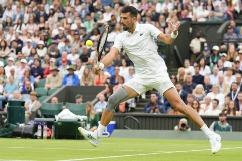 Novak Djokovic wins his first match at Wimbledon with a sleeve on his surgically repaired knee