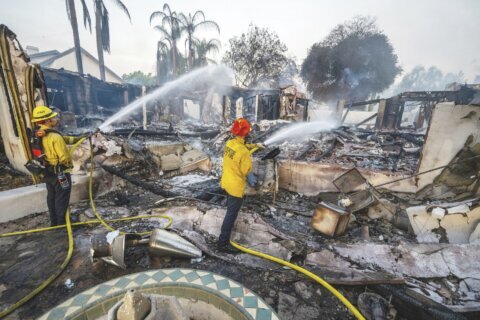Wildfires plague the West amid a scorching heat wave. Homes burn in Southern California