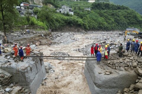 Rescuers search for dozens missing after flooding and a bridge collapse in China kill at least 25