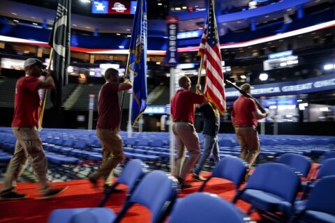 Donald Trump enters Republican convention hall with a bandaged ear and gets a hero's welcome