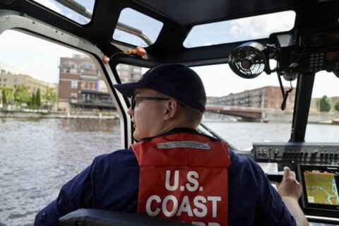 Heavily armed security boats patrol winding Milwaukee River during GOP convention
